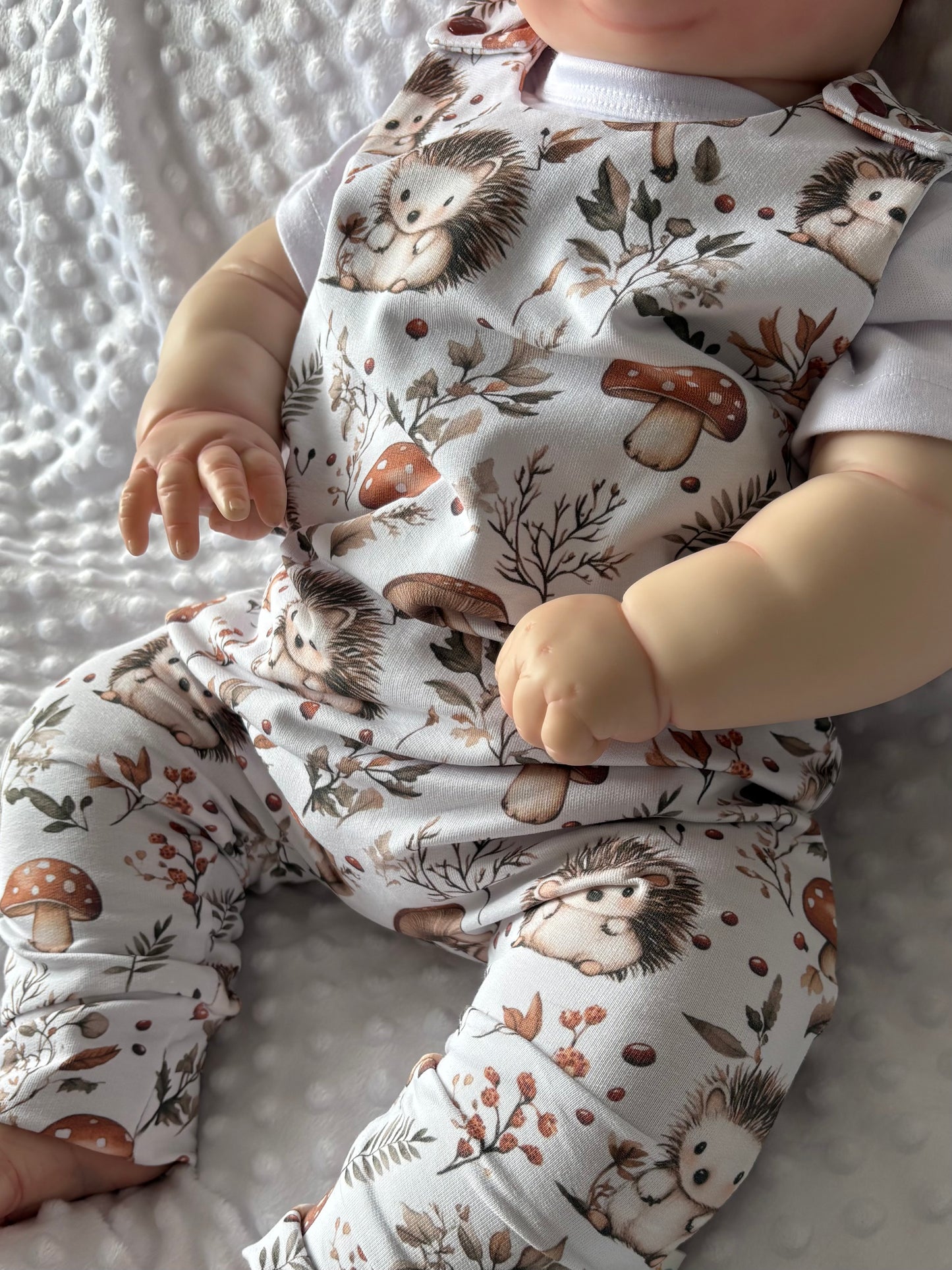 close up of baby dressed in hedgehog romper