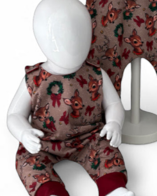 Close up view of Children's romper with reindeer pattern
