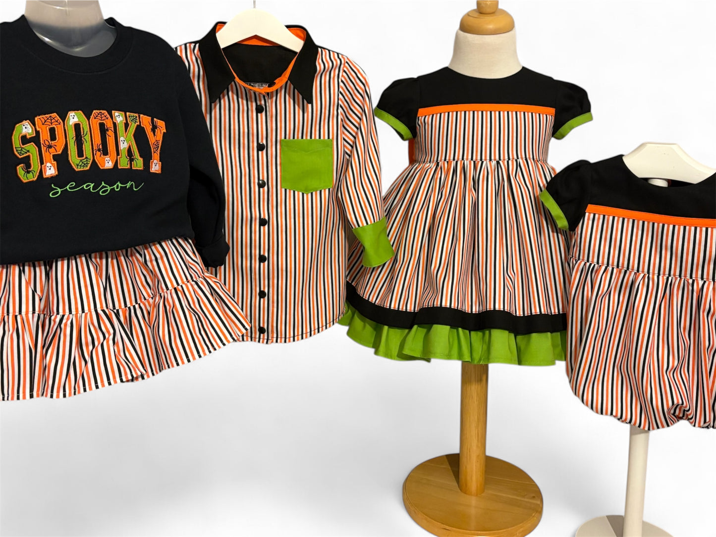 Children's Halloween-themed clothing on mannequins against a white background