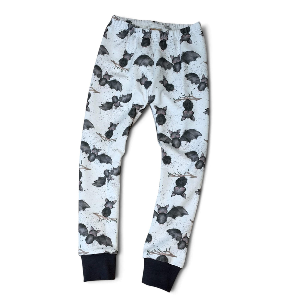 White leggings with an all-over black bat print and solid black ribbed cuffs, shown flat against a white background.