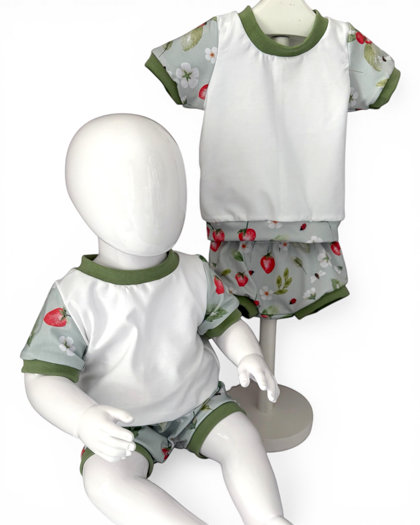 Personally Stitched handmade organic cotton jersey t-shirt and bummies set with a strawberry and floral print and green trim.