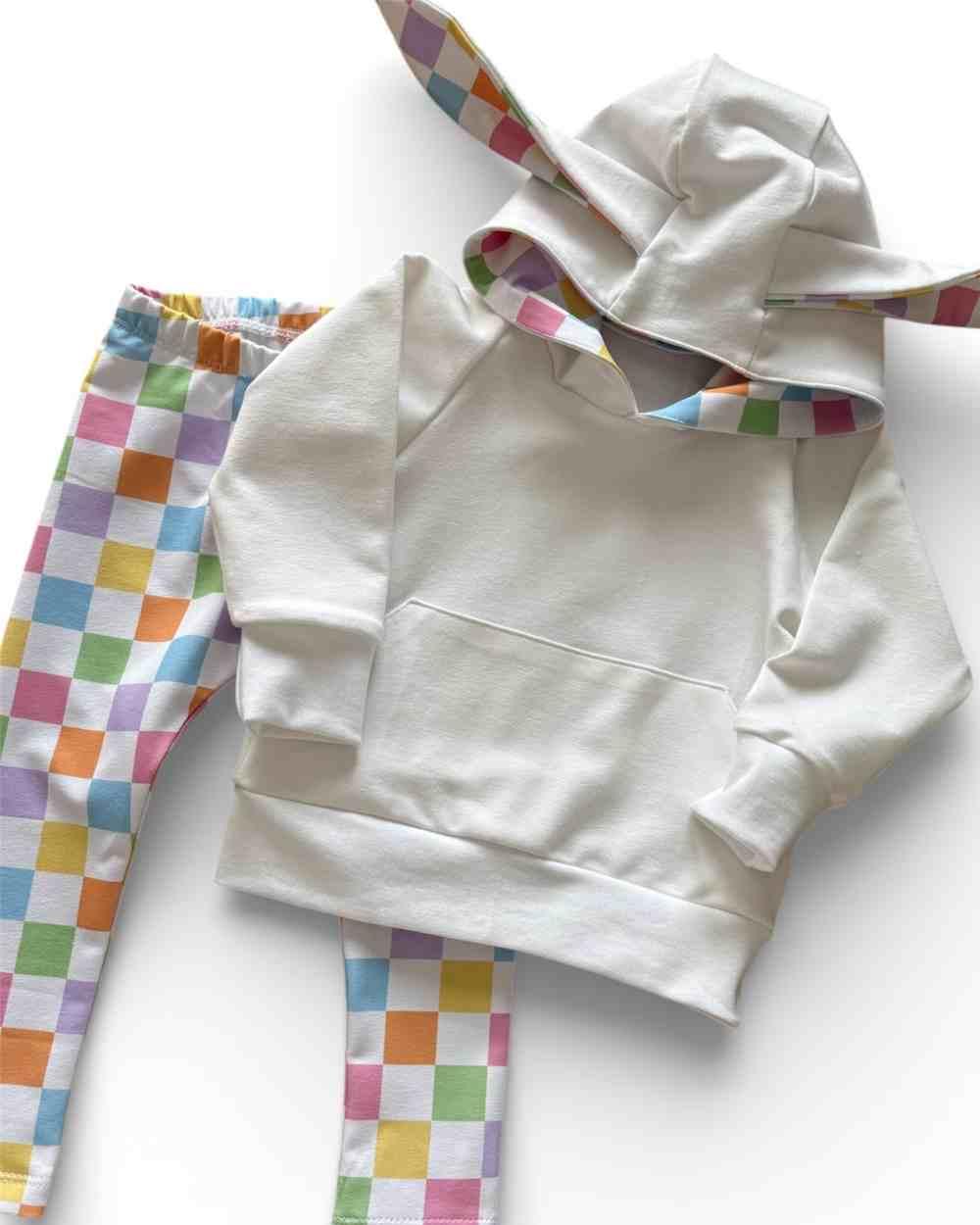 White hoodie and colorful checkered pants on a white background