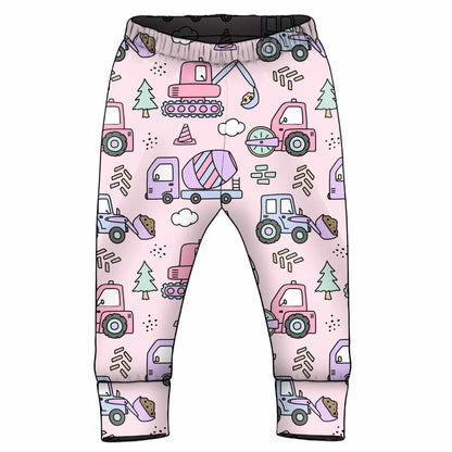 Children's pants with colorful truck pattern on a pink background