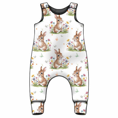Children's overalls with bunny and flower pattern on a white background