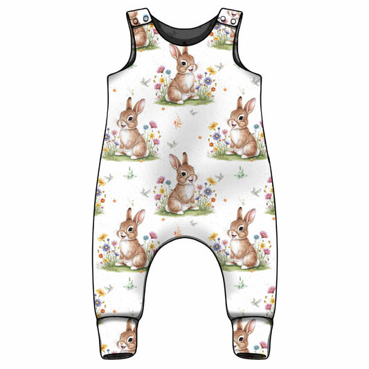 Children's overalls with bunny and flower pattern on a white background