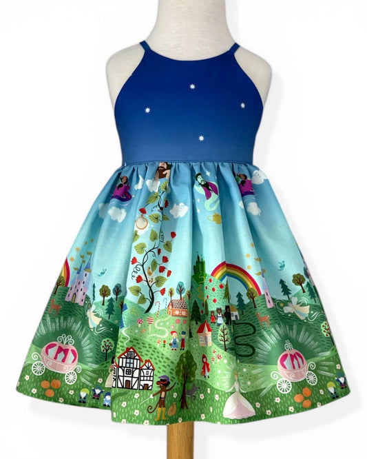 Dress with colorful fairy tale design on a mannequin against a white background
