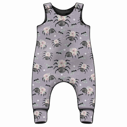 Handmade floral spider print baby romper with purple background 