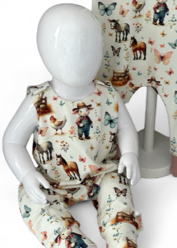 Child's outfit with animal print on a mannequin against a floral background