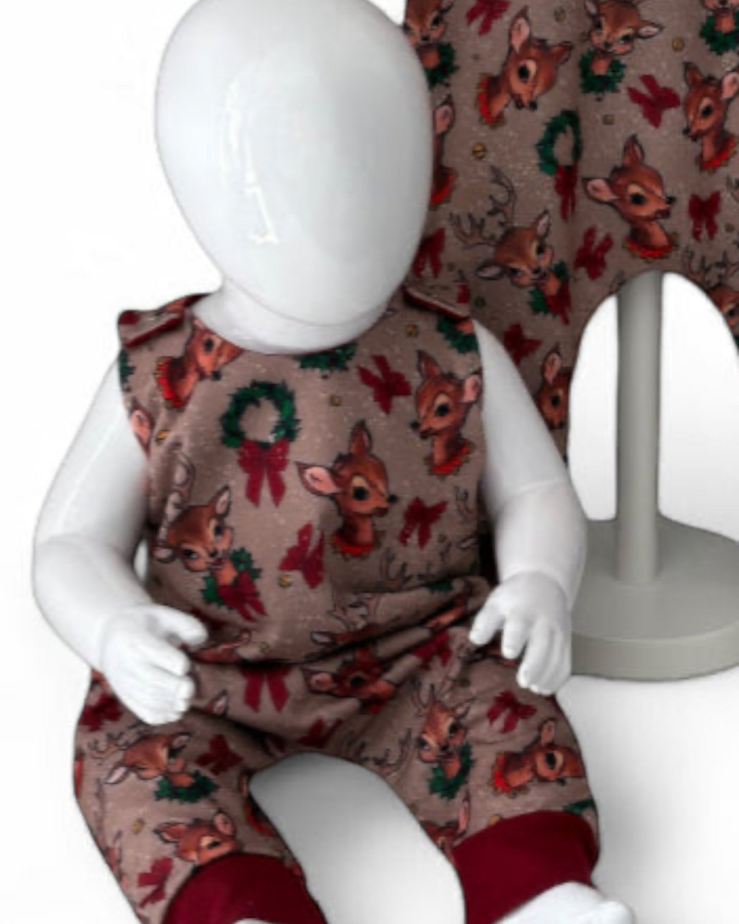 Close up view of Children's romper with reindeer pattern