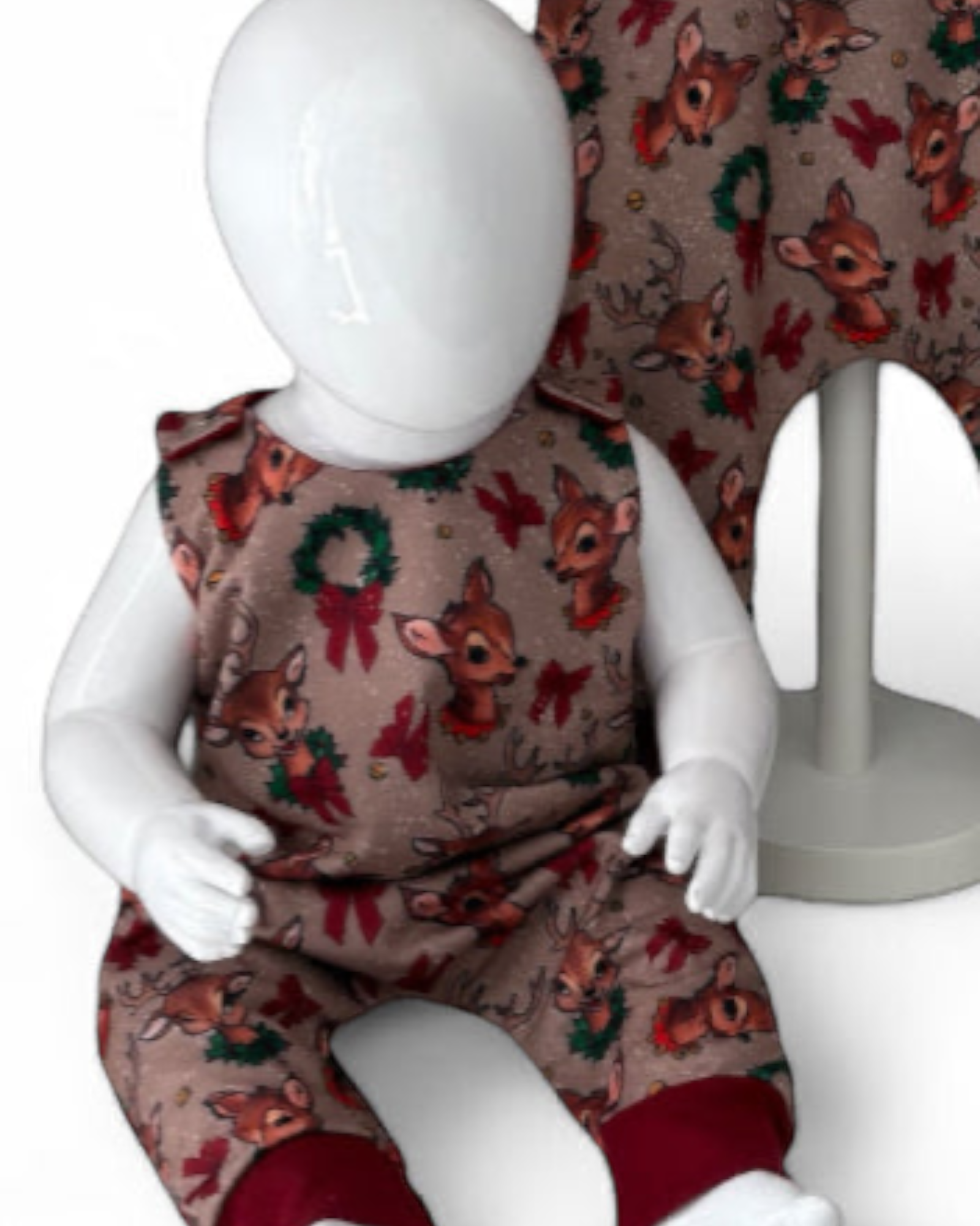 Close up view of Children's romper with reindeer pattern
