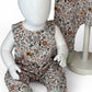 Floral-patterned children's overalls on a mannequin against a white background