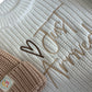 Organic-Style Neutral Baby Knit Set – Includes a cream ribbed knit romper with tan detailing and embroidered text, ideal as a baby shower gift.