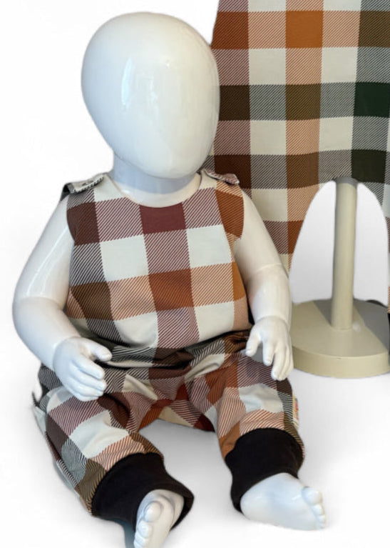 Mannequin wearing a plaid outfit with a checkered background