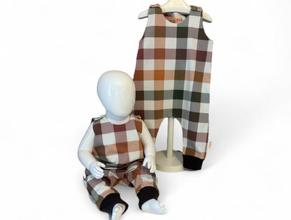 Children's plaid outfit with a matching romper and pants on mannequins against a white background.