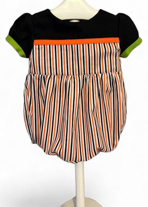 Front view of toddler Halloween romper – boutique-style outfit with festive stripes and playful seasonal colours.