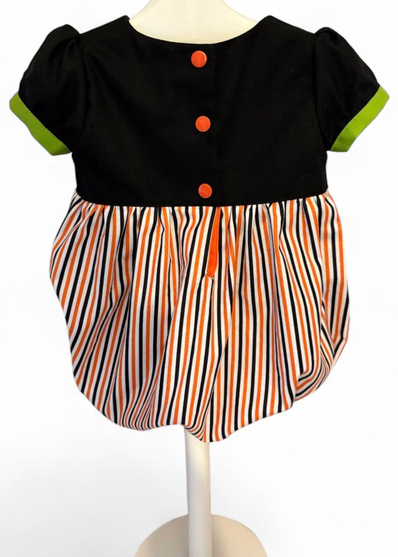 Back view of Halloween baby romper – handmade cotton romper with bow detail and snap fastenings for easy changes.
