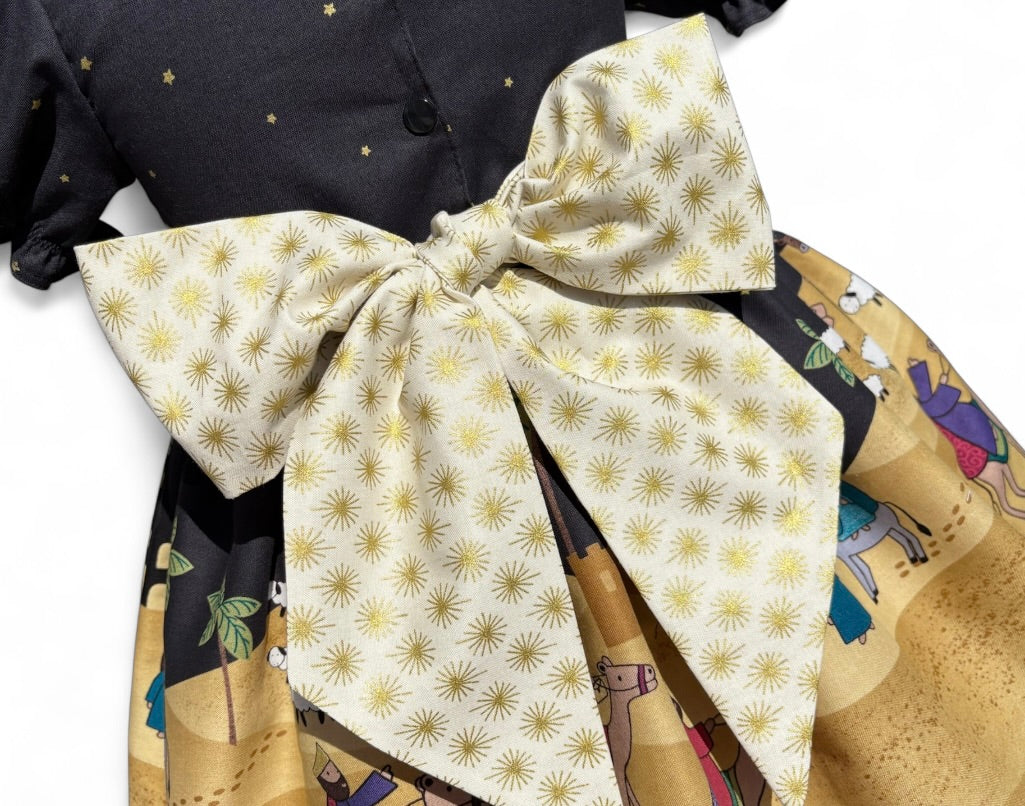 Festive toddler and girls dress featuring Away in a Manger nativity scene fabric, handmade in 100% cotton with puff sleeves and oversized bow.