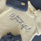 Personally Stitched Embroidered Baby Knit Sets – Gender-themed knit romper sets with soft blue and pink accents, including booties, hats, and textured knit blankets.