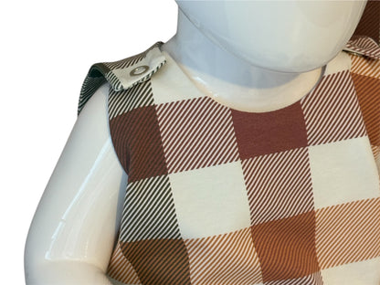 Mannequin wearing a plaid patterned garment with a white background