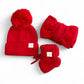 Red knit baby hat with pom-pom, matching headband, and booties