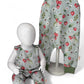 Children's strawberry print romper with floral patterns on a pale green  background
