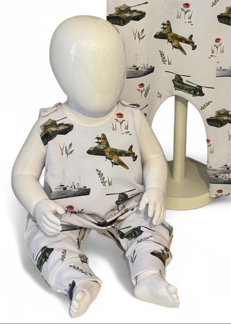 Children's romper with airplane pattern on a mannequin and hanger against a white background