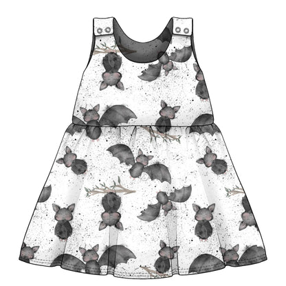 children's dress with bat print pattern on a white background