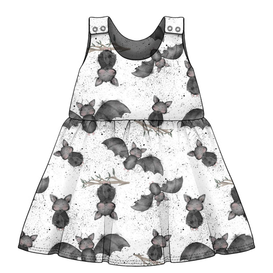 children's dress with bat print pattern on a white background