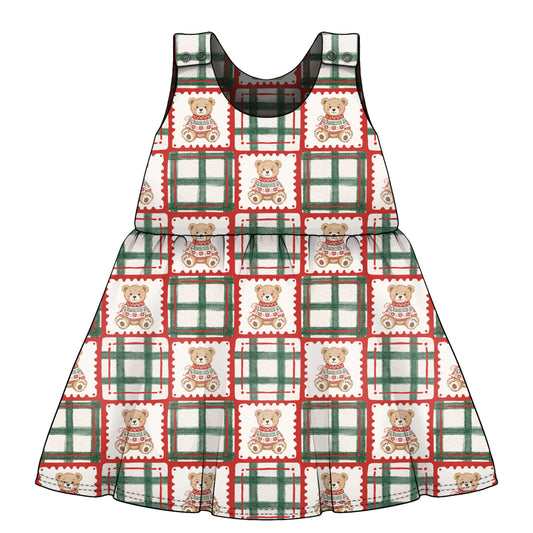 A sleeveless children's dress with a festive holiday pattern of teddy bears with green and red check frames on a white background. age 3 months to 6 years 