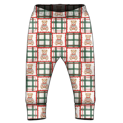 A pair of children's leggings with an all-over Christmas-themed pattern featuring green and red plaid squares and teddy bears, shown against a plain white background.