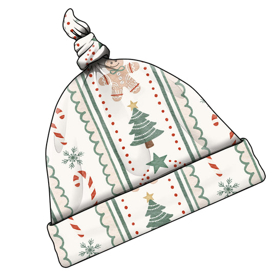 A knotted baby hat with a festive Christmas pattern featuring green trees, red candy canes, snowflakes, and stars on an off-white background.