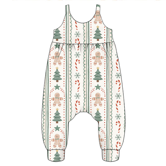 A baby romper or jumpsuit with a Christmas holiday print, featuring gingerbread men, Christmas trees, candy canes, and snowflakes on a cream background.