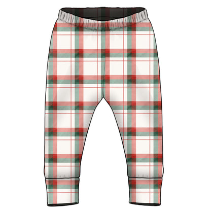 A pair of children's plaid pants with an elastic waistband and ribbed ankle cuffs, featuring a white base with red and green tartan Christmas colours