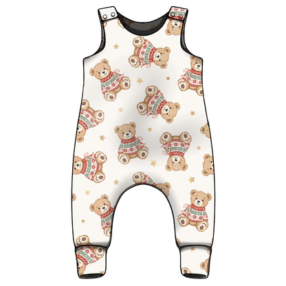 A baby Christmas romperwith an all-over print of teddy bears wearing colourful knit sweaters and small gold stars, set against a plain white background.