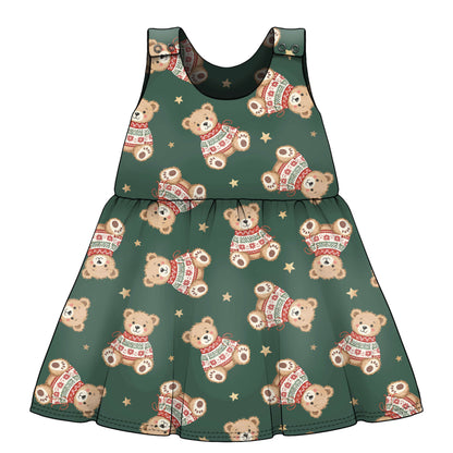 A sleeveless baby dress with a festive holiday print featuring teddy bears wearing red and green sweaters and small gold stars on a dark green base French Terry fabric..