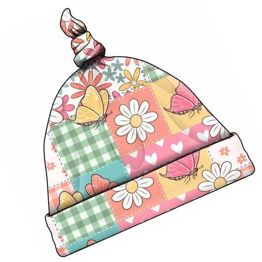 Colourful baby and toddler patchwork beanie with floral and butterfly pattern.