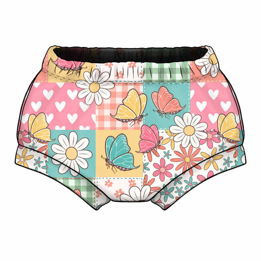 Baby Shorts with a colourful butterfly and flower pattern on a patchwork background