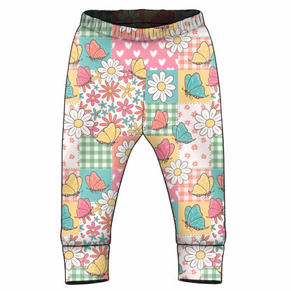 Colourful patterned pants with flowers and butterflies on a patchwork background