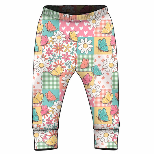 Colourful patterned pants with flowers and butterflies on a patchwork background