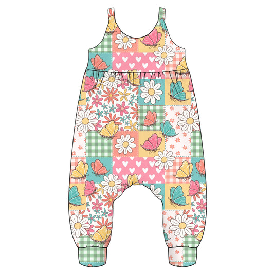Colourful children's overalls with floral and butterfly pattern in a patchwork design background