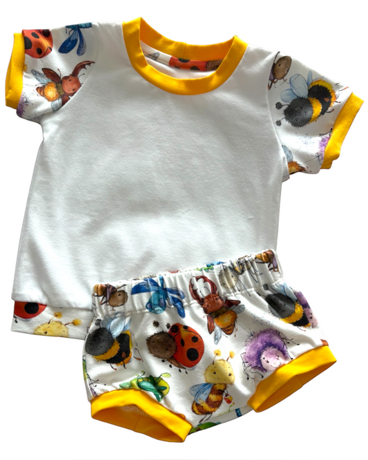 Personally Stitched white organic jersey t-shirt and bummies set with a playful bug print and yellow trim. Suitable for 0-3 months.