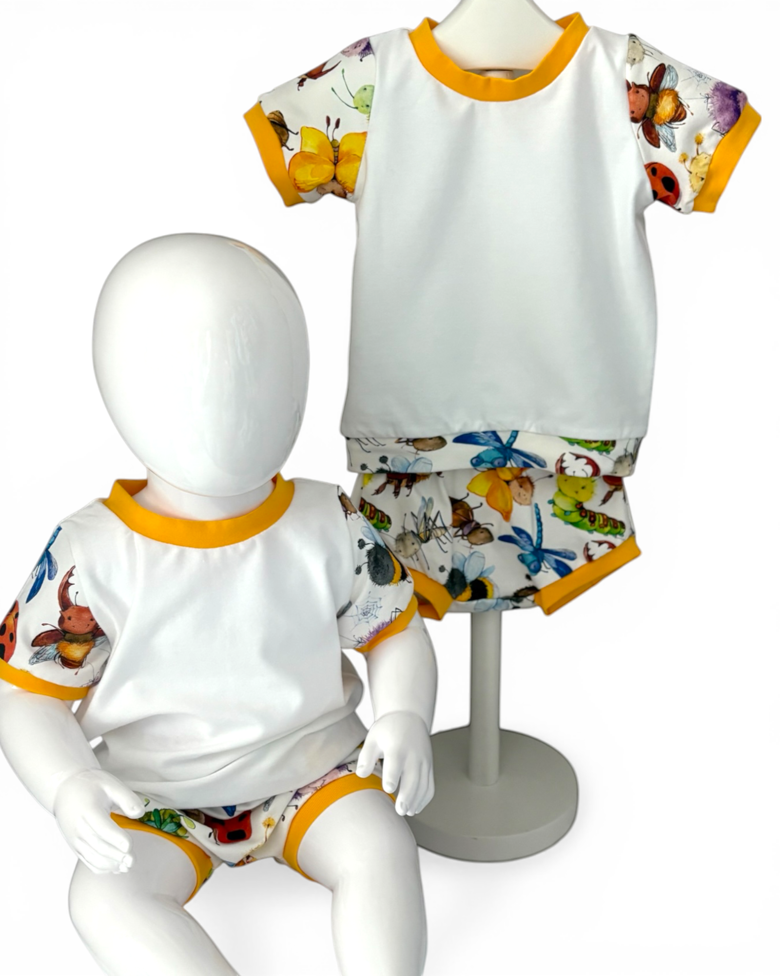 Personally Stitched white organic cotton jersey t-shirt and bummies set with a playful bug print and yellow trim. Size 3-6 months.