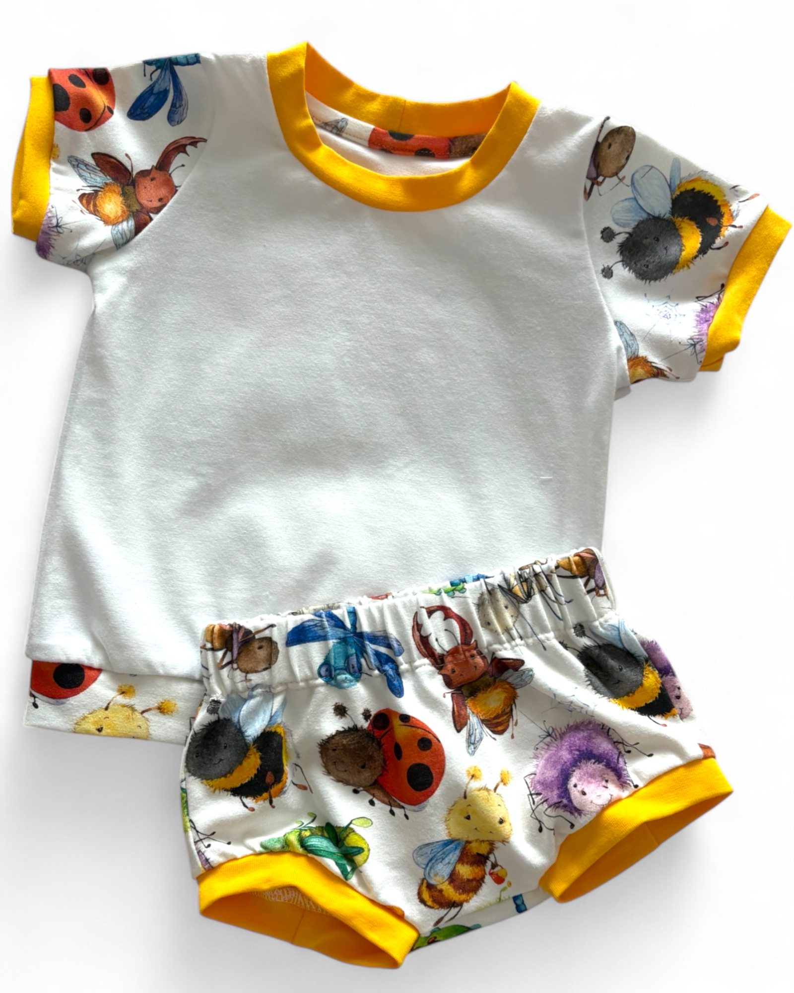 Personally Stitched white organic cotton jersey t-shirt and bummies set with a playful bug print and yellow trim.