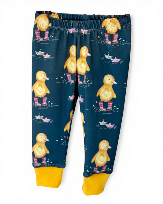 Personally Stitched navy blue organic cotton jersey leggings with a cute duckling print and yellow cuffs. Size 6-9 months.
