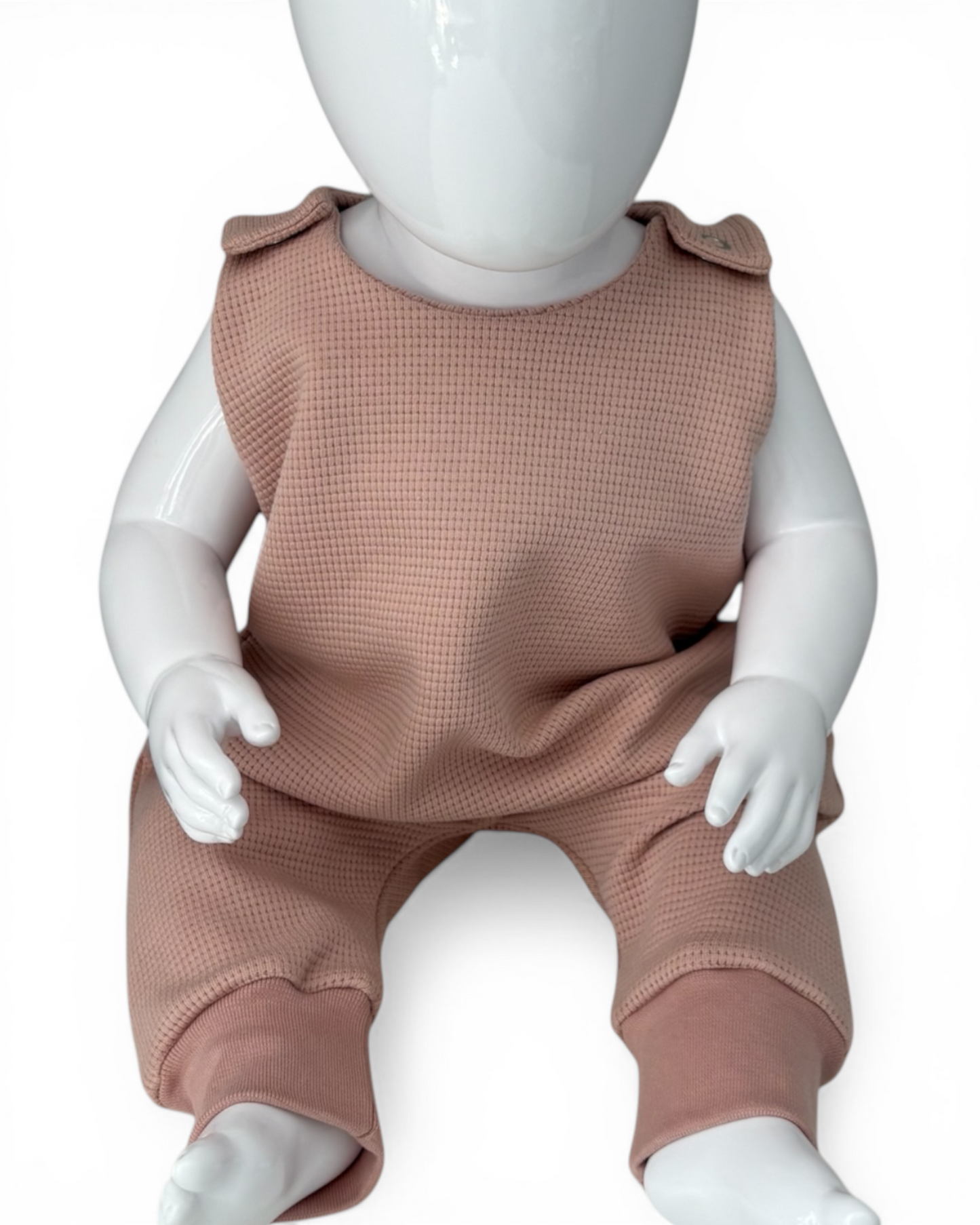 Personally Stitched nude pink waffle knit 100% cotton baby romper, 0-3 months, with snap closures.