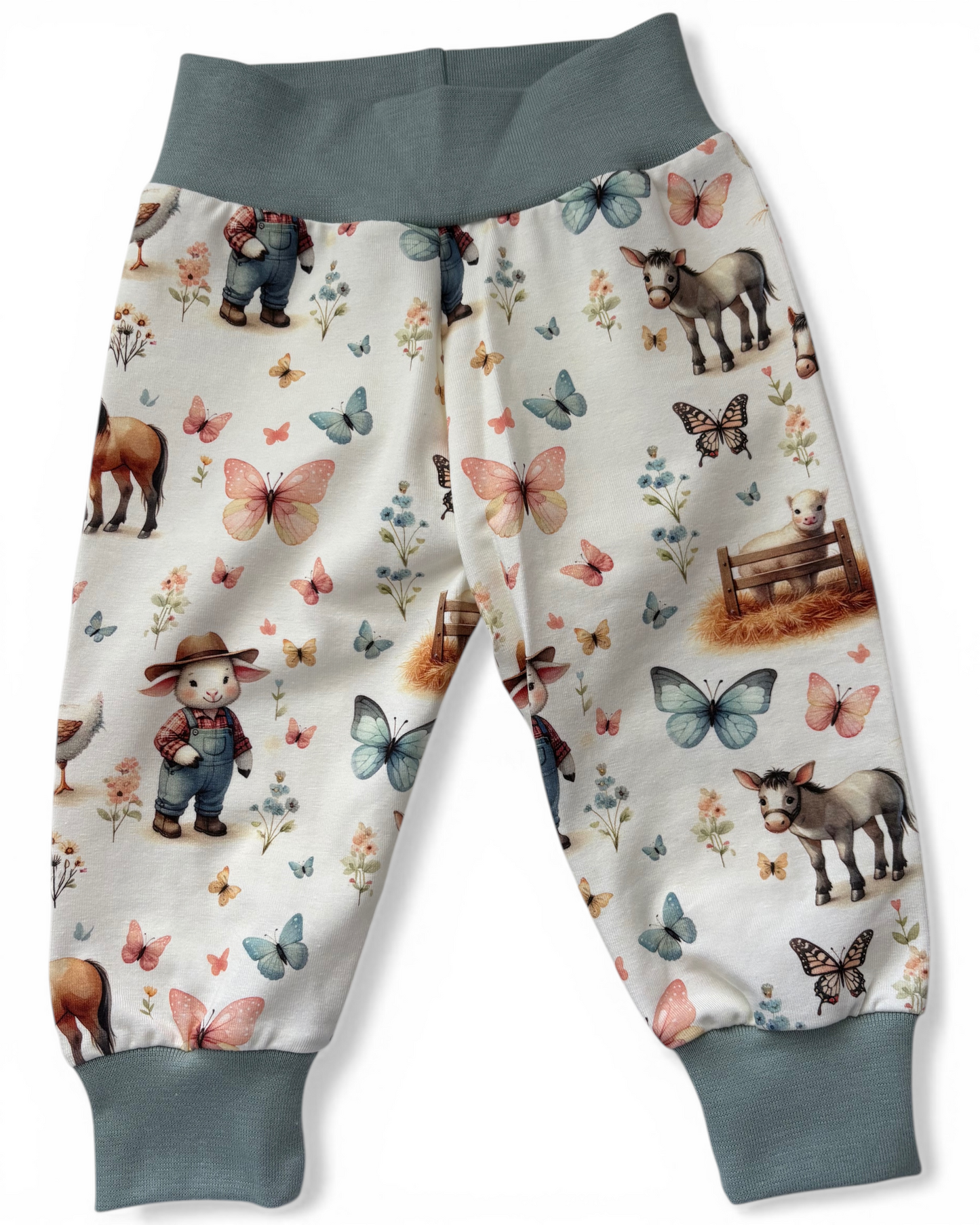 Personally Stitched sea green organic cotton jersey joggers with a farm animal and butterfly print, featuring a yoga waistband and cuffed ankles.
