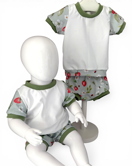 Personally Stitched handmade organic cotton jersey t-shirt and bummies set with a strawberry and floral print and green trim.