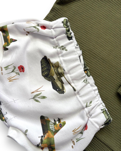 Personally Stitched army green waffle knit baby jumper with white shorts featuring a vintage military print of tanks and planes.