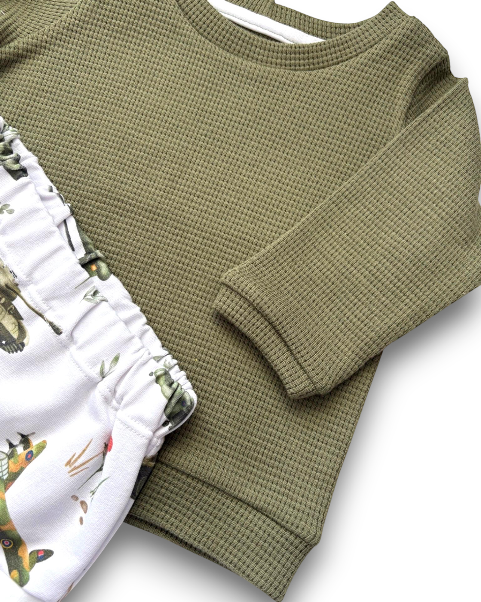 Personally Stitched army green waffle knit jumper with white shorts featuring vintage military aircraft print. Comfortable baby outfit.