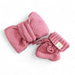 Pink knitted baby headband and booties set on a white background